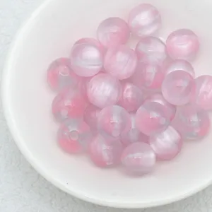 Close-up detail of pink and white cat eye beads showing smooth jelly texture and shiny surface.