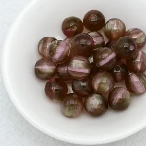 Close up of imitation cat eye jelly beads in white bowl, perfect for DIY jewelry making.