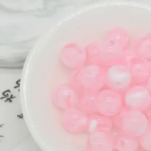 Pink swirled acrylic beads detail showing the marble texture and smooth surface for DIY crafts.