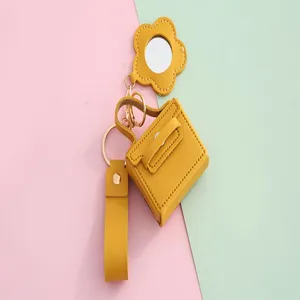 Gele PU lederen mini handtas sleutelhanger met bloem spiegel en polsbandje accessoire.