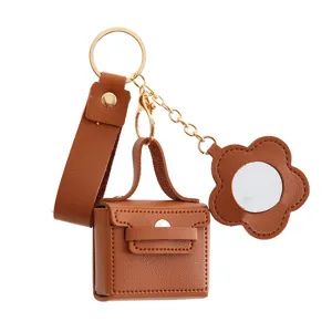 Bruine PU lederen minihandtas sleutelhanger oordopje tas met spiegel hanger bloem ontwerp.