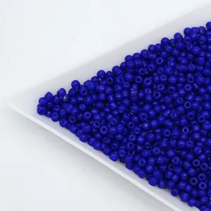 Detailed shot of royal blue glass seed beads, perfect for DIY handmade jewelry bracelets.