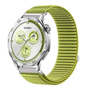 Detailed view of the green woven nylon watch strap with stainless steel connector and buckle.