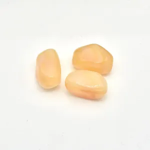 Close-up of irregular marbled acrylic stone beads, peach color DIY jewelry accessory detail.