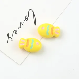 Close-up of colorful acrylic painted fish beads, perfect for DIY jewelry and phone chain design.