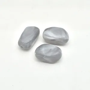 Detail shot of grey marbled irregular acrylic beads, perfect for DIY jewelry and crafts.