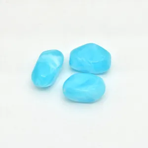 Detailed view of light blue irregular marbled acrylic beads for handmade jewelry DIY craft projects.