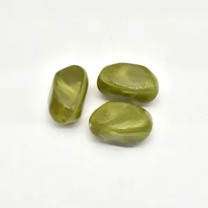 Close-up of olive green marbled acrylic beads, smooth irregular pebble shape with drill hole.
