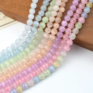 Closeup of colorful macaron glass cat eye beads strands, perfect for DIY jewelry making.
