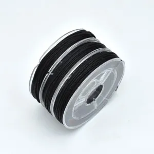 Black jade cord spool detail shot, ideal for DIY bracelets, jewelry making and beading crafts.