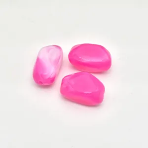Close-up detail of irregular acrylic pink imitation stone beads for DIY jewelry making.