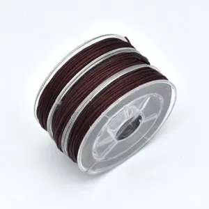 Dark brown jade cord detail view, nylon thread spool for DIY jewelry making and bracelet crafting.