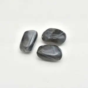 Close-up of irregular smoke patterned acrylic imitation stone loose beads for DIY jewelry making.
