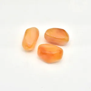 Close-up detail view of irregular orange acrylic imitation stone loose beads for DIY jewelry making.