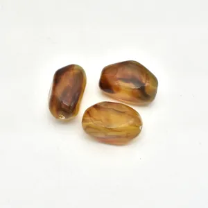 Close up view of irregular marbled acrylic beads for DIY handmade jewelry accessories