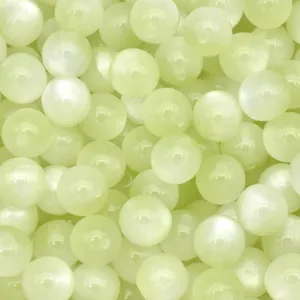 Resin cat eye beads detail close up texture view showing smooth surface and pearlescent shine.