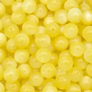 Close up of yellow resin cat eye beads detail, perfect for DIY jewelry making and crafts.