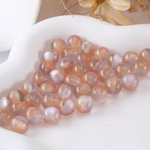 Close-up detail shot of shiny resin round beads with glitter for DIY handmade jewelry bracelets.