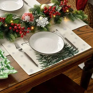Detailed shot of Christmas placemat featuring festive tree and snowflake patterns on wooden table.