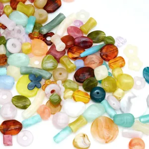 Close-up detail of mixed acrylic beads, colorful vintage loose beads for DIY jewelry making.