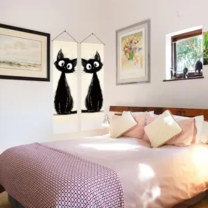 Detailed shot of cute black cat hanging tapestry in bedroom, elegant linen tassel wall art decor.