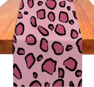 Dettaglio runner da tavola con stampa leopardo rosa, decorazione cucina sala da pranzo tessuto.
