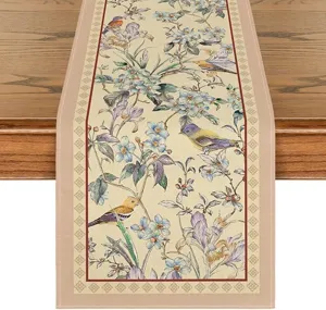 Spring floral and bird pattern table runner, linen fabric dining table decoration detail view.