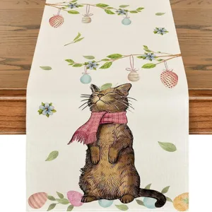 Detailed close-up of a linen table runner featuring a cute cat illustration and Easter eggs.