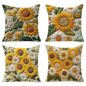 Vue détaillée de housses de coussin brodées en 3D tournesols et marguerites.