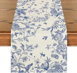 Linen table runner with blue floral and bird print, detailed view of the botanical dining table decor.