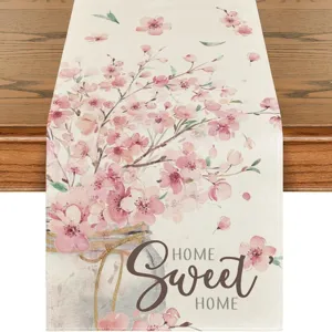Close-up detail of fabric table runner featuring watercolor cherry blossoms and jar design.