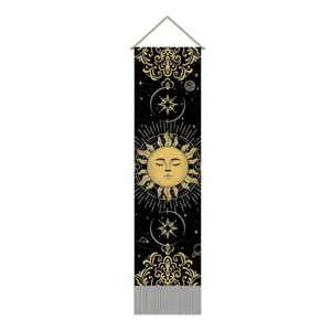 Detailed view of the black and gold celestial tapestry featuring sun and moon design with tassels.