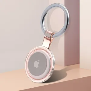Clear pink protective case with metal ring for Apple AirTag tracker accessory display.