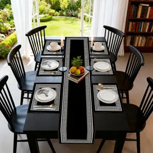 Black table runner and placemats set with geometric Greek key pattern for kitchen dining room decor.