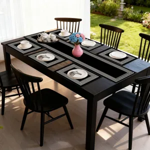 Black table runner and placemat set with geometric Greek key pattern for dining room decor.