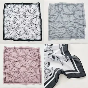 Detalle de pañuelo cuadrado de seda, diseño de estampado floral elegante, bordes finos.