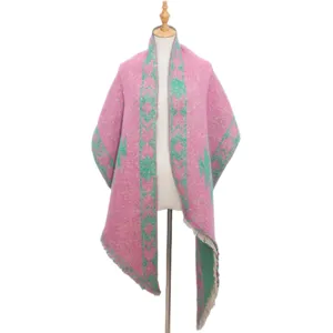 Detailed view of the pink and green thick knit shawl, showing winter cozy texture and fabric.