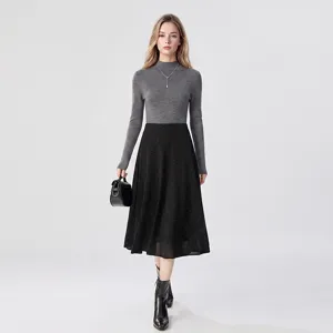 Detail shot of elegant grey mock neck wool knit sweater paired with black midi skirt outfit.