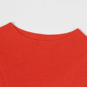 Close-up detail of a bright orange mock turtleneck knitted sweater collar, fine texture.