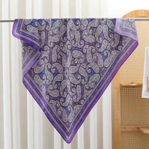 Detailed view of a purple paisley square silk satin scarf, elegant summer women headwear.