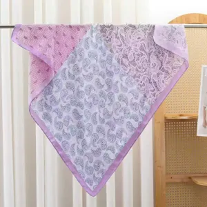 Detailed close-up view of a purple paisley patterned square scarf with delicate lace details.