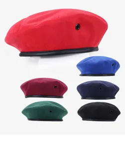 Detailed view of colorful wool beret hats, featuring metal eyelets and leather trim.