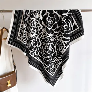 Exquisite black and white camellia pattern silk scarf, elegant detailed view for summer style.