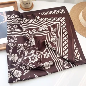 Elegant dark brown silk-feel square scarf featuring classic white floral and geometric patterns.