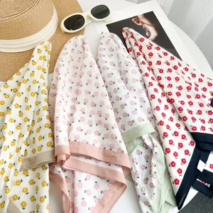 Detailed shot of floral print cotton square scarf with color block border, spring summer style.