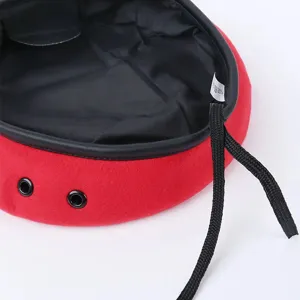 Red wool beret hat featuring black leather trim, eyelets and drawstring for fashion style.