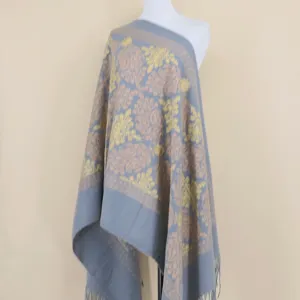 Detailed view of grey cashmere shawl scarf with gold metallic embroidery and fringe tassels