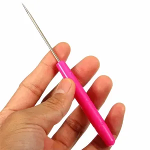Close-up detail view of a pink fondant cookie scribe needle with fine metal tip for baking.