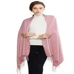 Pink tassel cashmere-feel shawl detail view, soft autumn winter wrap texture close-up.