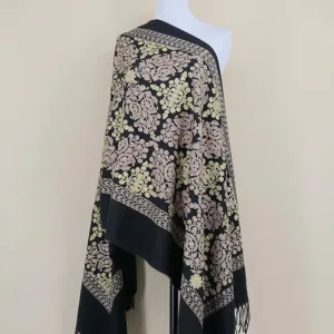 Detailed view of black cashmere shawl featuring delicate gold and pink floral embroidery patterns.